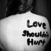 a woman with writing on their back suffering from Domestic Violence by Proxy