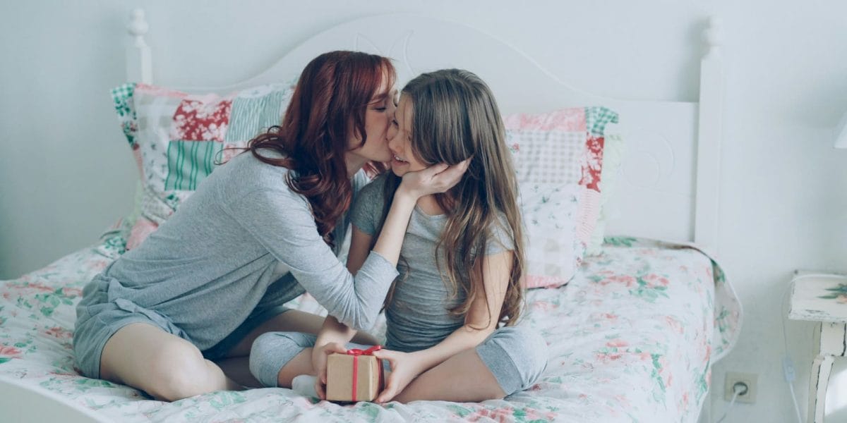 Woman kissing daughter who needs to think about Hiring a Child Custody Attorney